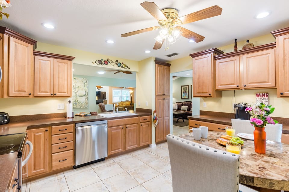 Large kitchen with stainless steel appliances and table for two