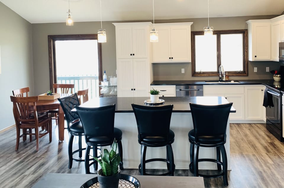 Modern kitchen includes granite countertops and new appliances.