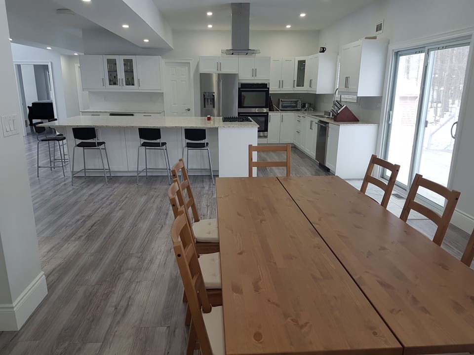 Dining room table seats up to 8.  Deck located immediately through patio doors. 