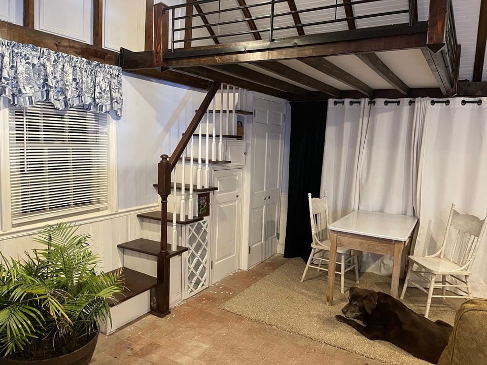 Loft with full size bed, above the stairs. 