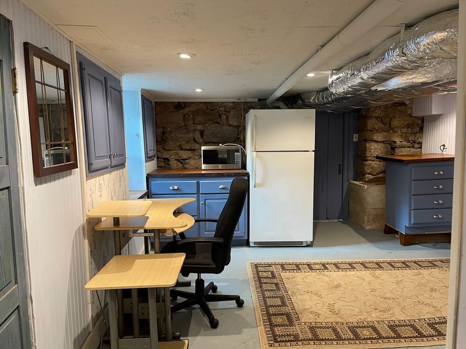 Additional room with desk, refrigerator, microwave, washer/dryer and storage