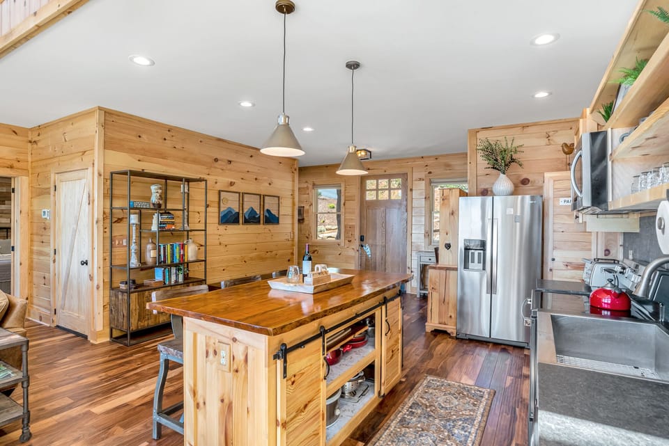 View of kitchen and front of house from dining table