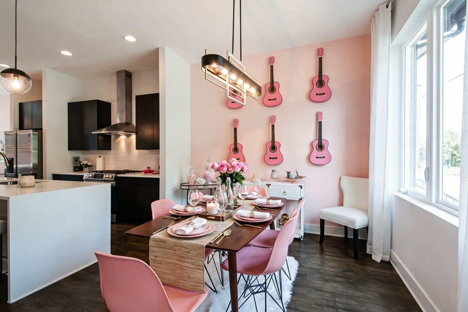 Dinners in this dining room aren't just meals. Guitar decorations and pink chairs turn every table setting into part of the Dolly tribute