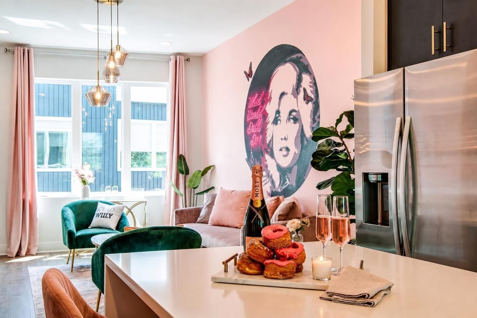 The open kitchen flows right into the living room, so the cook stays part of the fun. A Dolly Parton mural watches over every meal and morning coffee