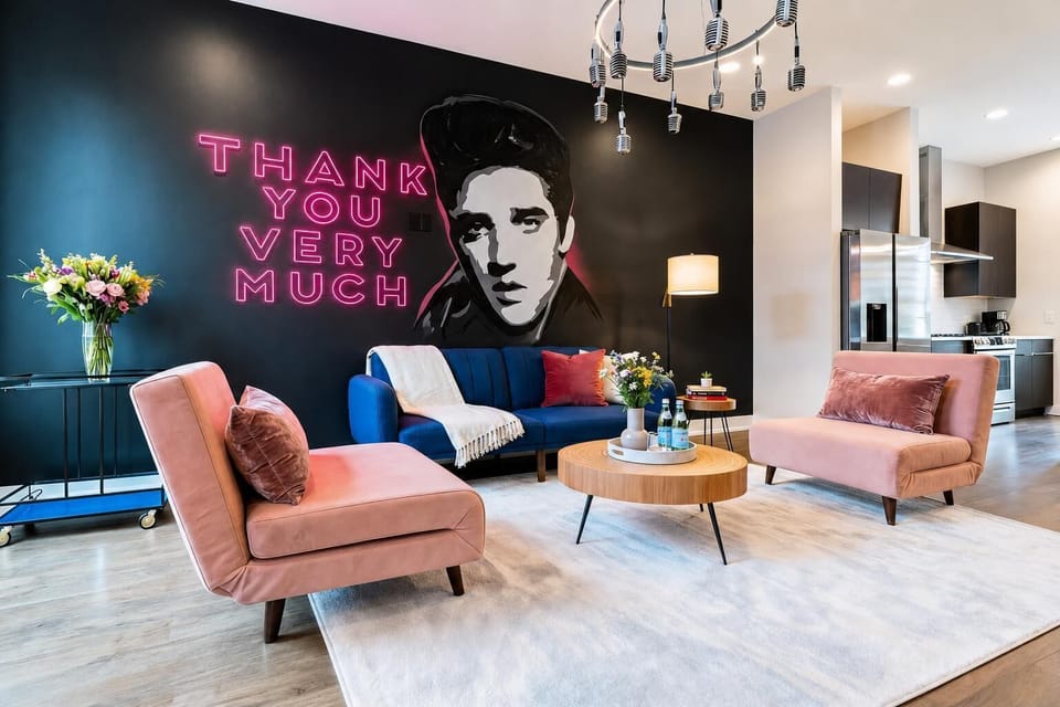 The Elvis mural and neon marquee signs set the tone the moment you walk in; blue and pink seating and a modern chandelier complete the living room scene. Reserve your stay with Misfit Homes and live out your Elvis fantasy