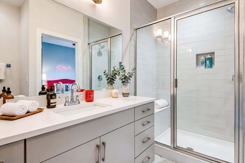 Second full bathroom with walk-in shower and grey vanity, because a group of twelve needs more than one place to get ready