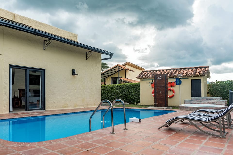 Spacious pool with hammock, loungers, and dining terrace.