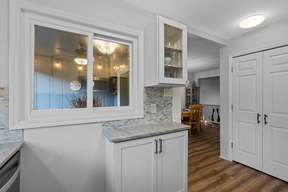 Window from kitchen overlooks covered porch.