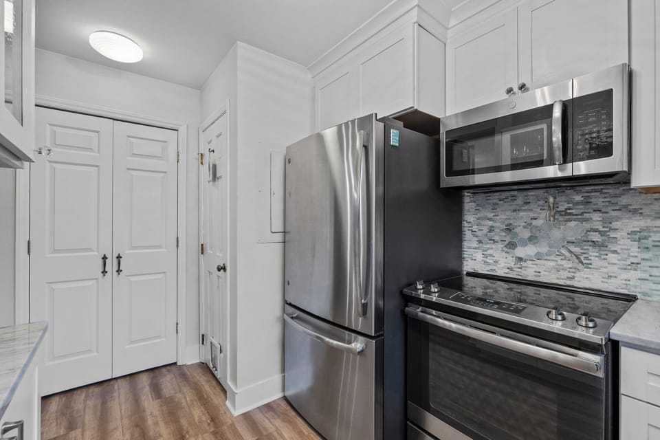Large pantry for storage behind double doors, powder room to right.