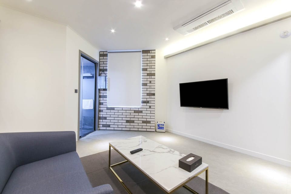 Junior suite with styler,air purifier,1PC | Living area | 49-inch flat-screen TV with cable channels, TV