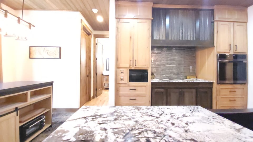 Quality 36-inch Bosch induction cooktop paired with a striking custom range hood