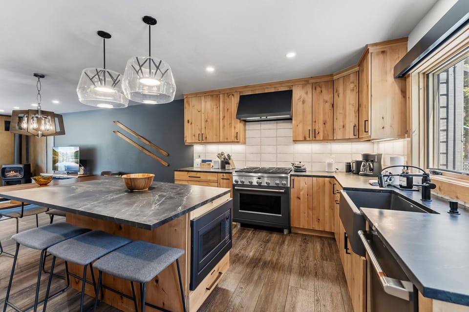 Kitchen: High-end appliances, island with bar seating, drip coffee maker