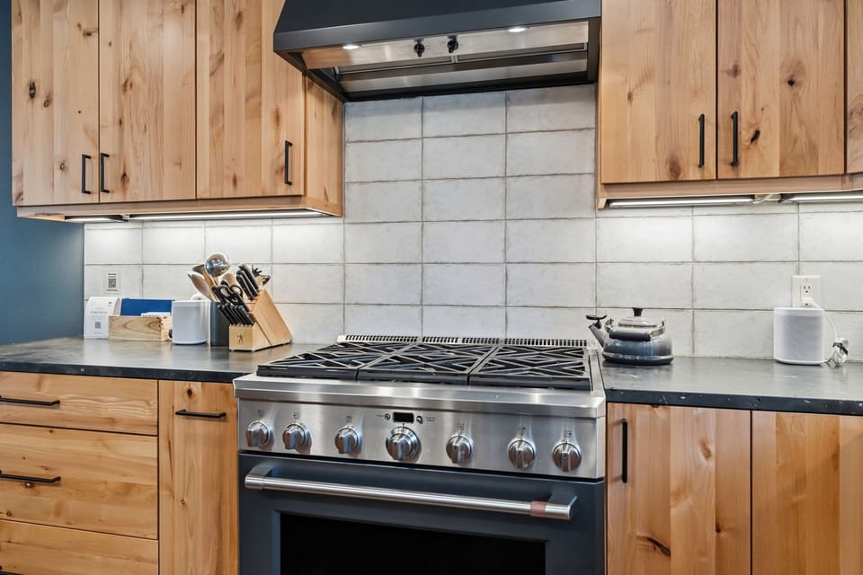 Kitchen: High-end appliances, island with bar seating, drip coffee maker