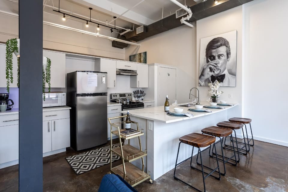 Cook and entertain in a sleek, fully-equipped kitchen featuring modern appliances, ample counter space, and all the essentials for a seamless dining experience in the heart of Fort Worth.