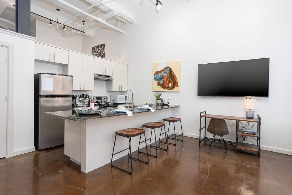 Cook and entertain in a sleek, fully-equipped kitchen featuring modern appliances, ample counter space, and all the essentials for a seamless dining experience in the heart of Fort Worth.