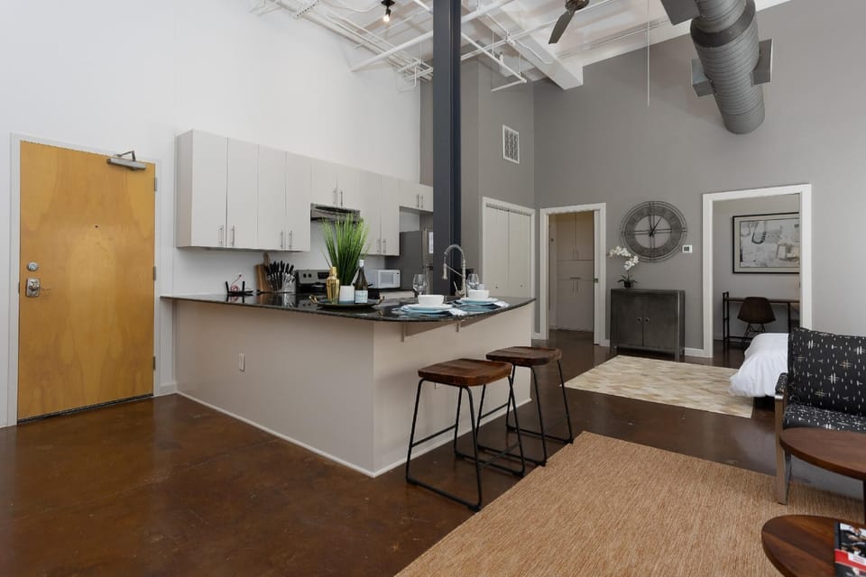 Cook and entertain in a sleek, fully-equipped kitchen featuring modern appliances, ample counter space, and all the essentials for a seamless dining experience in the heart of Fort Worth.