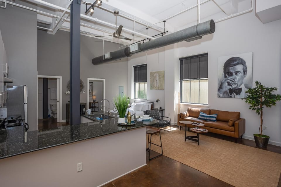 Relax in the spacious, beautifully designed living area, complete with cozy seating and chic decor, offering a perfect retreat after exploring Fort Worth’s lively downtown scene.