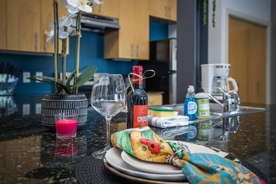 Cook and entertain in a sleek, fully-equipped kitchen featuring modern appliances, ample counter space, and all the essentials for a seamless dining experience in the heart of Fort Worth.