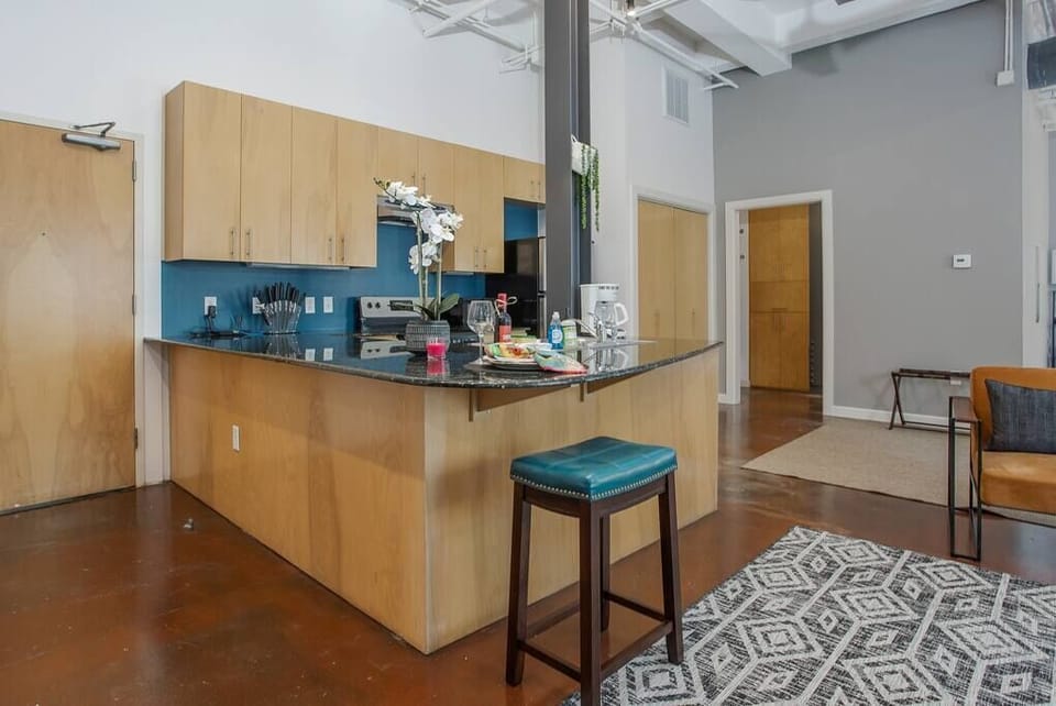 Cook and entertain in a sleek, fully-equipped kitchen featuring modern appliances, ample counter space, and all the essentials for a seamless dining experience in the heart of Fort Worth.
