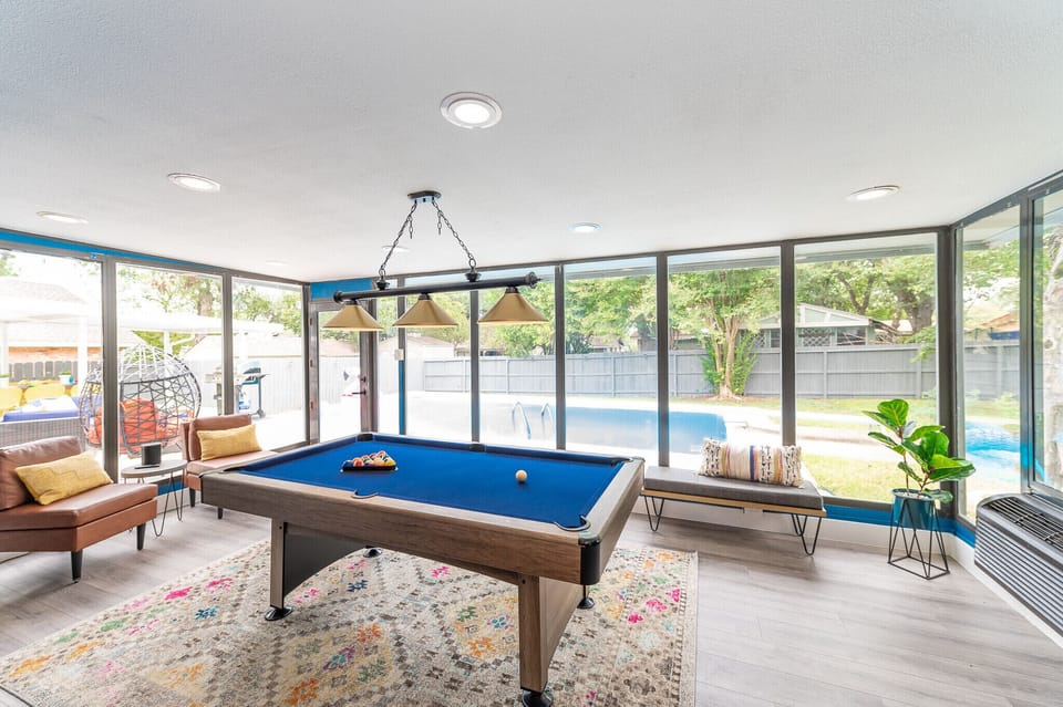 Gameroom/Sunroom area with a beautiful view of the pool and a pool table. 