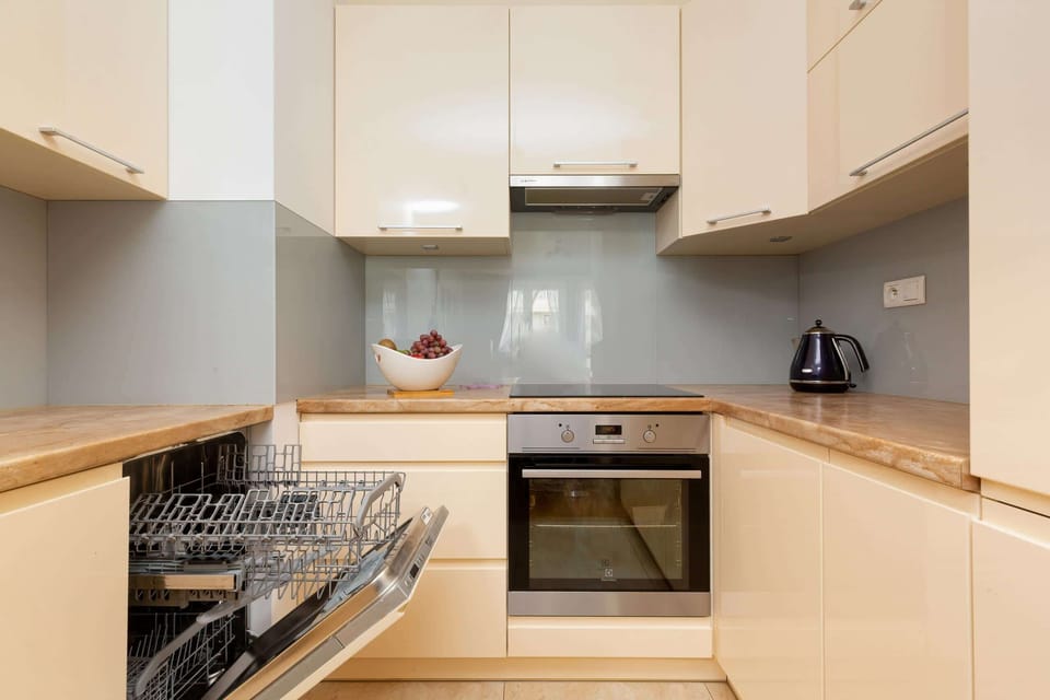 Kitchenette with oven and refrigerator. 