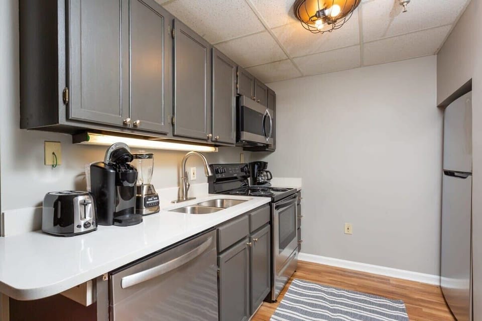 Kitchen With Stainless Steel Appliances and Quart Countertops!