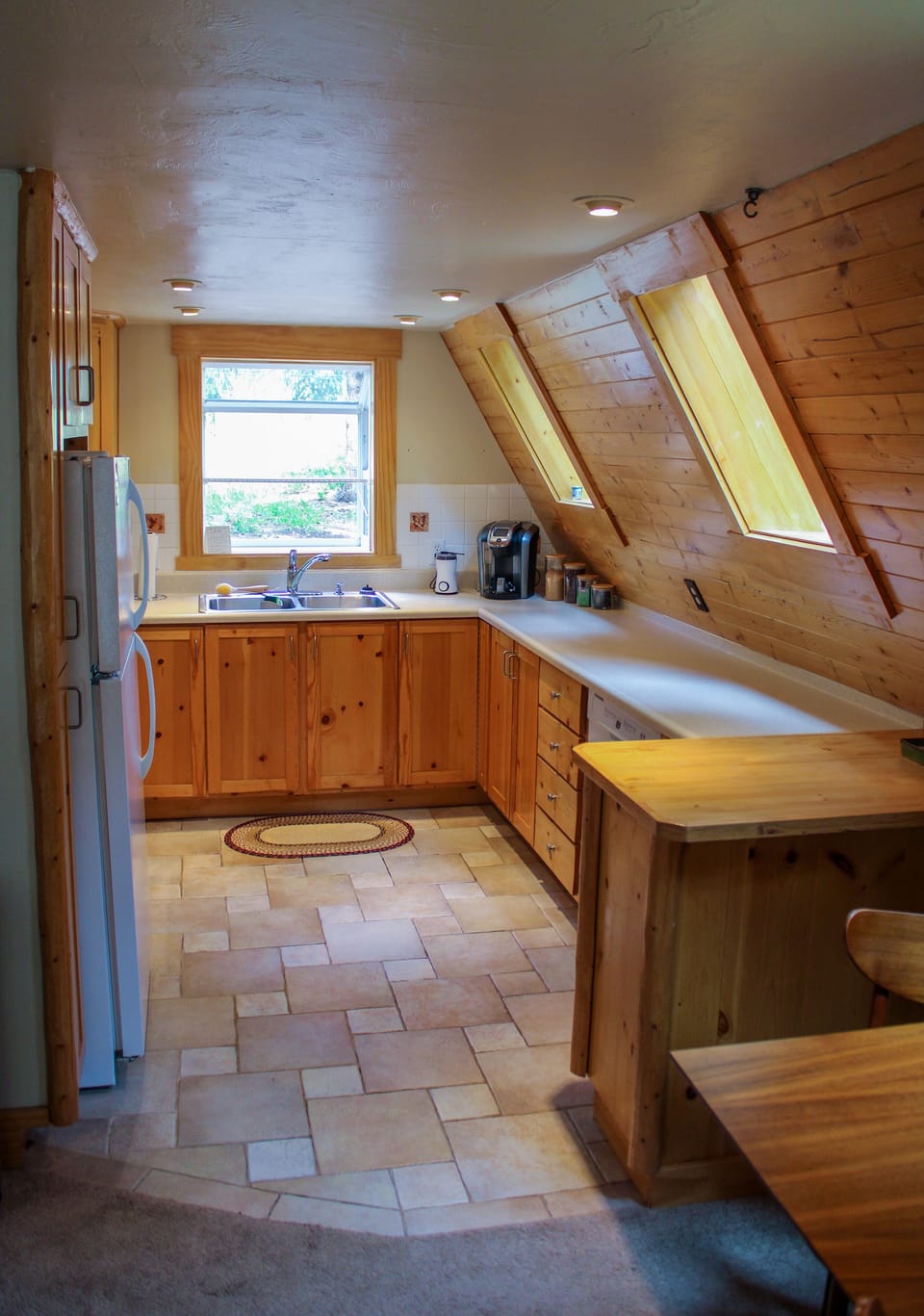 Sink with window nook above. Dishwasher  included. Skylights above countertops. 