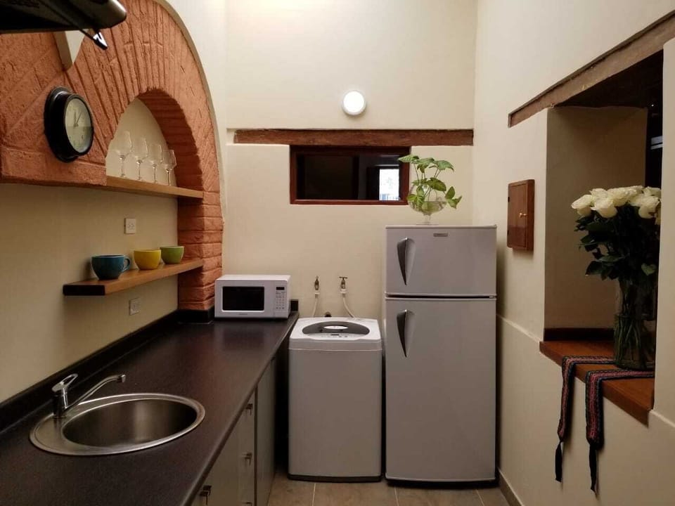 Complete kitchen with washer machine.