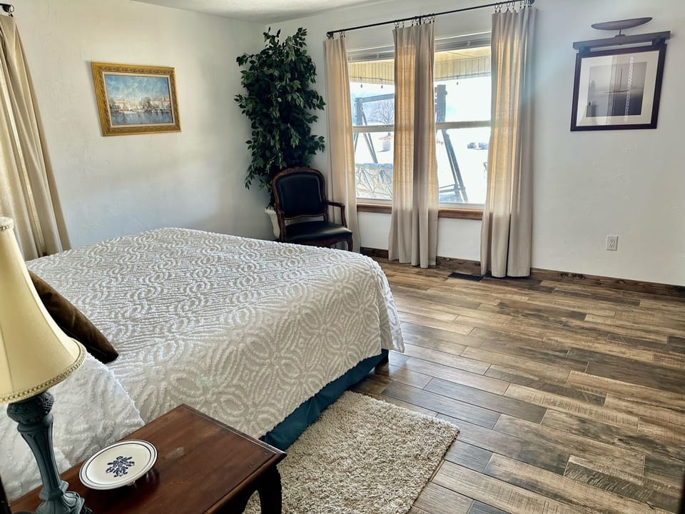 Master bedroom sitting area w/fantastic lake view, patio/fire pit in background