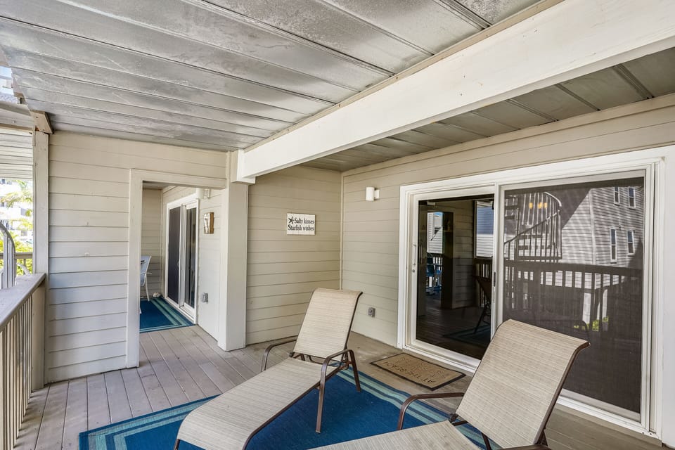 Double-wide balcony with reclining lounge chairs and Adirondack chairs