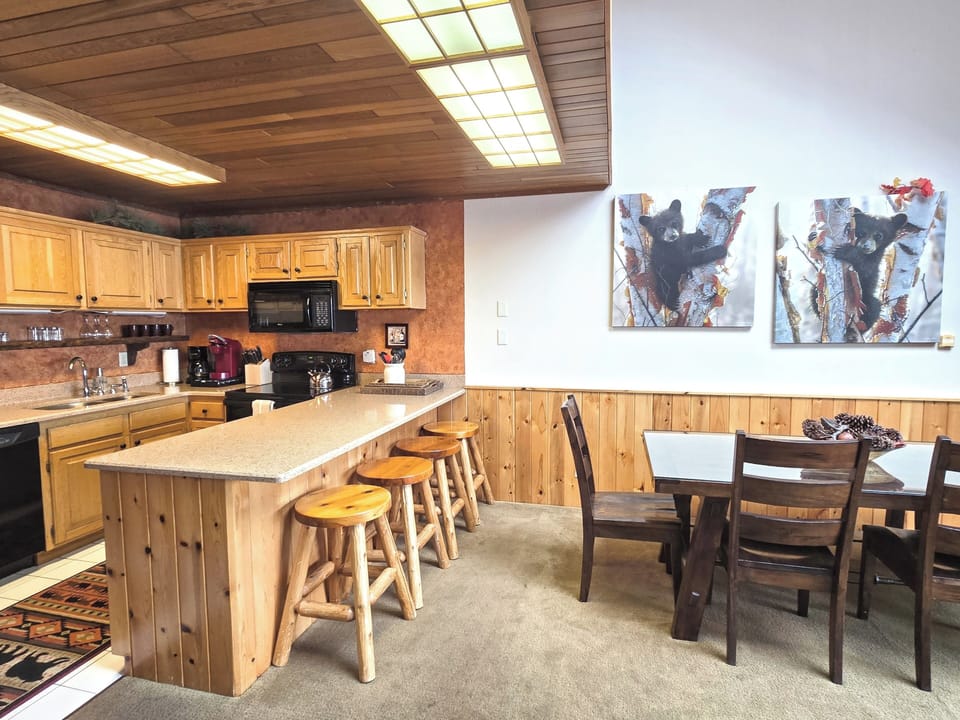 Rustic kitchen with bar + 6-seat dining—fully equipped for family meals