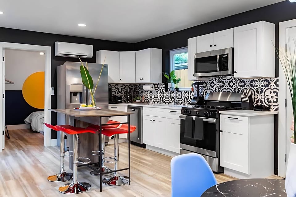 Fully Equipped Kitchen With Open Concept Design, Island, And Unique Lighting Features