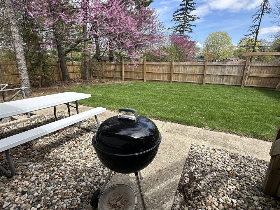 Backyard with picnic table and grill