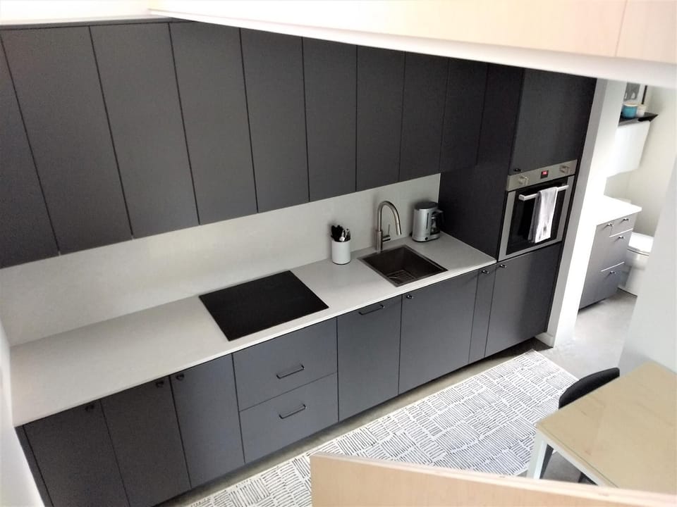 The highly-efficient, fully stocked kitchen includes an oven, induction range, dishwasher, toaster oven, microwave, and more.