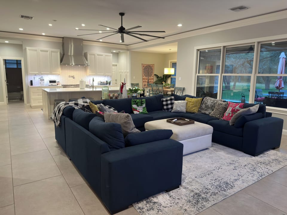 Open concept living room / kitchen with 84" TV