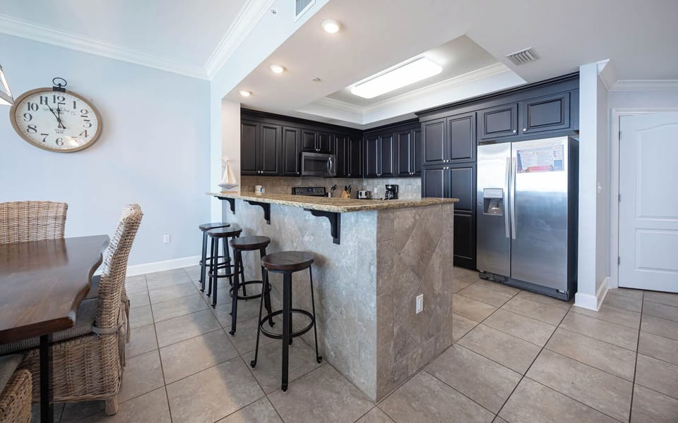 Gather at the sleek granite bar or dining table, enjoying the inviting atmosphere and stylish decor