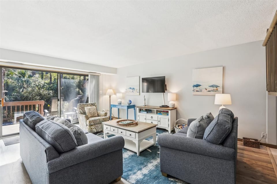 Living Room with Access to Back Deck and Screened Porch at 1402 South Beach Villas