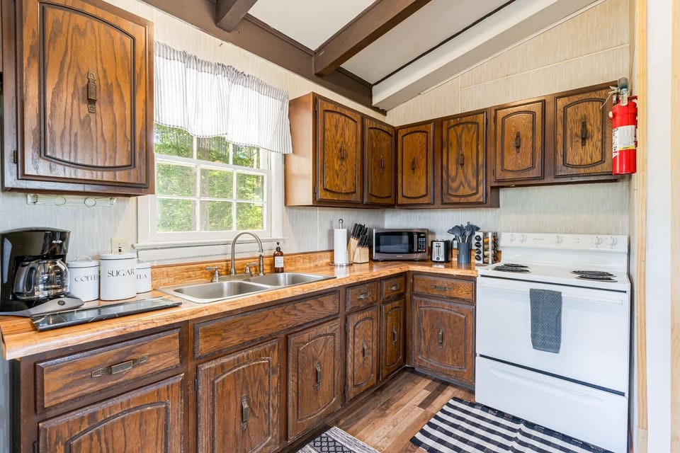 Fully-stocked kitchen with a stove/oven, microwave, and everything you need for cooking or grilling