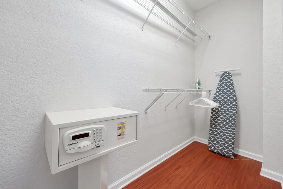 Your private laundry room features a modern washer, built-in ironing board, and organized shelving for effortless garment care during your stay.