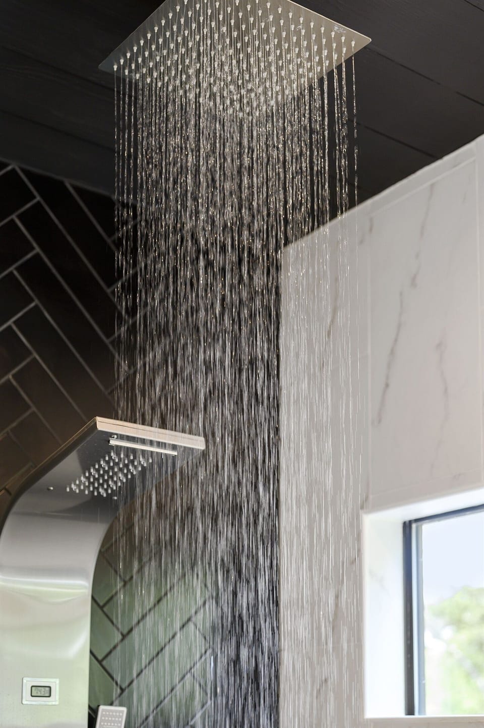Close-up of a rainfall shower with a sleek, modern design, offering a relaxing and rejuvenating experience. Perfect for a spa-like retreat.