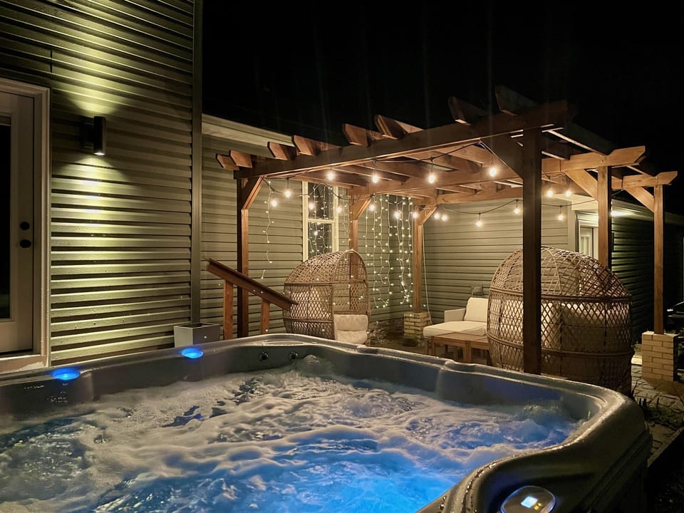 Soak in the hot tub with the dazzling lights on the porch 