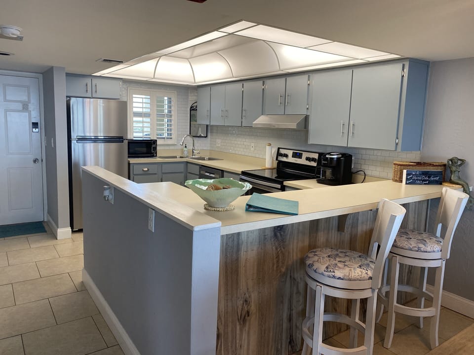 Full kitchen with bar area with additional seating for dining
