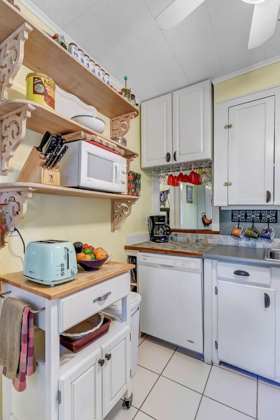 - Bright and colorful kitchen equipped with toaster, microwave, and plenty of shelving
- Perfect for preparing breakfast, storing snacks, and brewing fresh coffee
- Cheerful and compact space with style and charm throughout