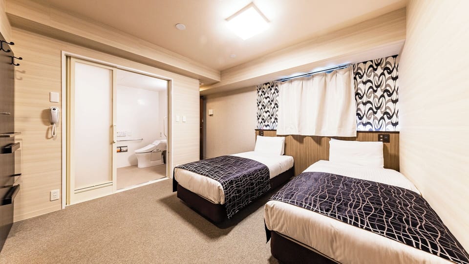 Universal Twin Room, Non Smoking | Down comforters, desk, laptop workspace, blackout drapes