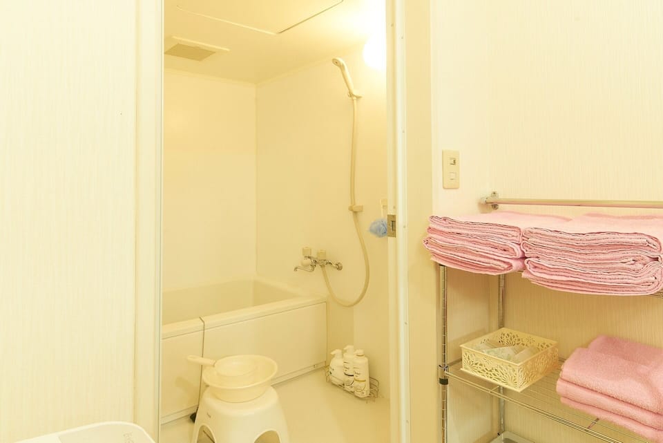 It is a large bathroom. Shampoo, conditioner, body soap