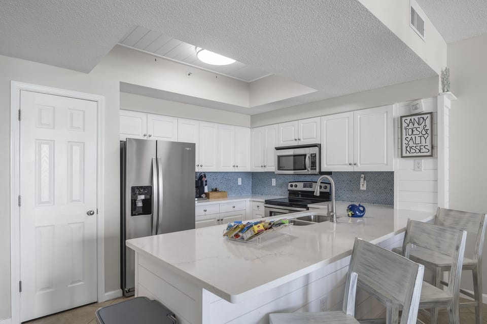Kitchen has GULF VIEWS, granite countertops, stainless appliances - fully stocked with more than the basics (coffee/tea bar, oils/salt and pepper, Tupperware, plenty of pots/pans/cookware)