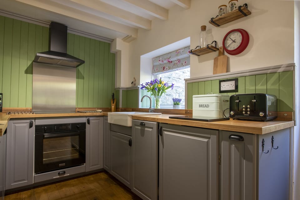 Ground floor: Delightful cottage kitchen with Belfast sink overlooking the patio area