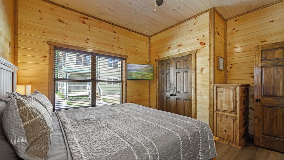 The comfortable queen bed offers a welcoming place to rest and recharge. Its convenient main-level location makes it easy to access without navigating stairs.