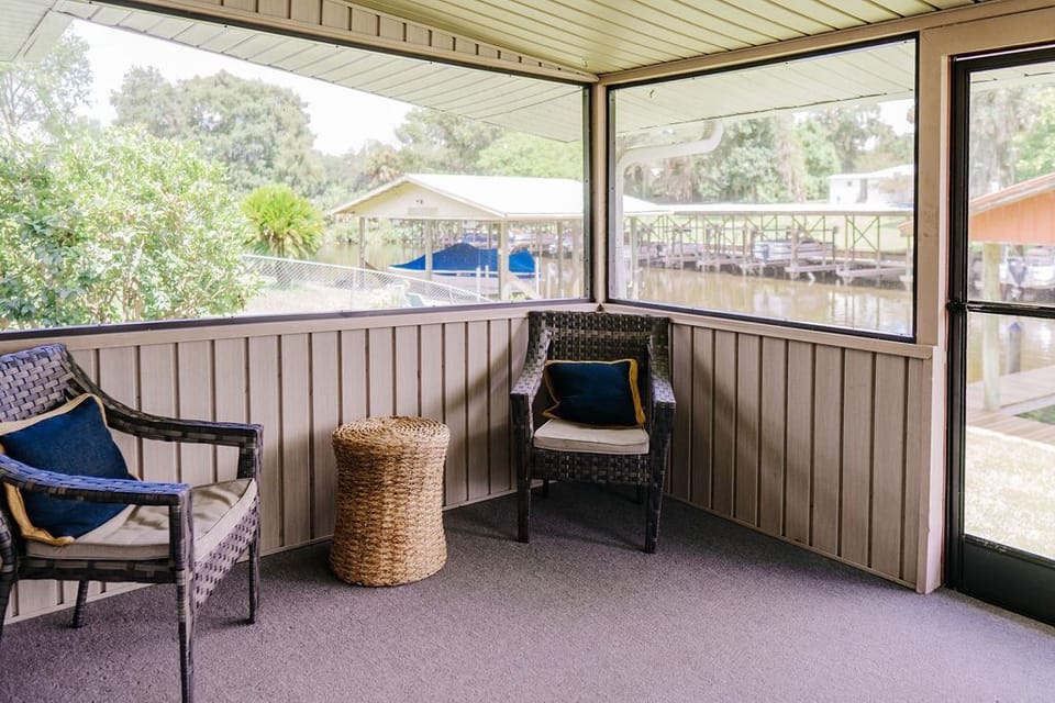 Screened in back porch with a water view 