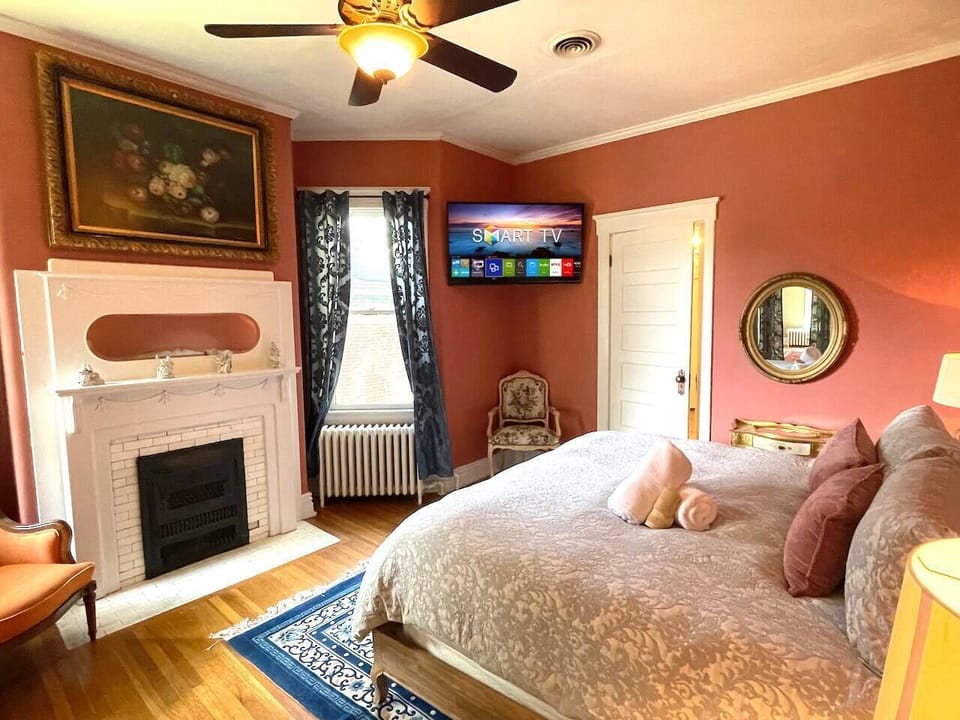 Primary bedroom with fireplace and TV